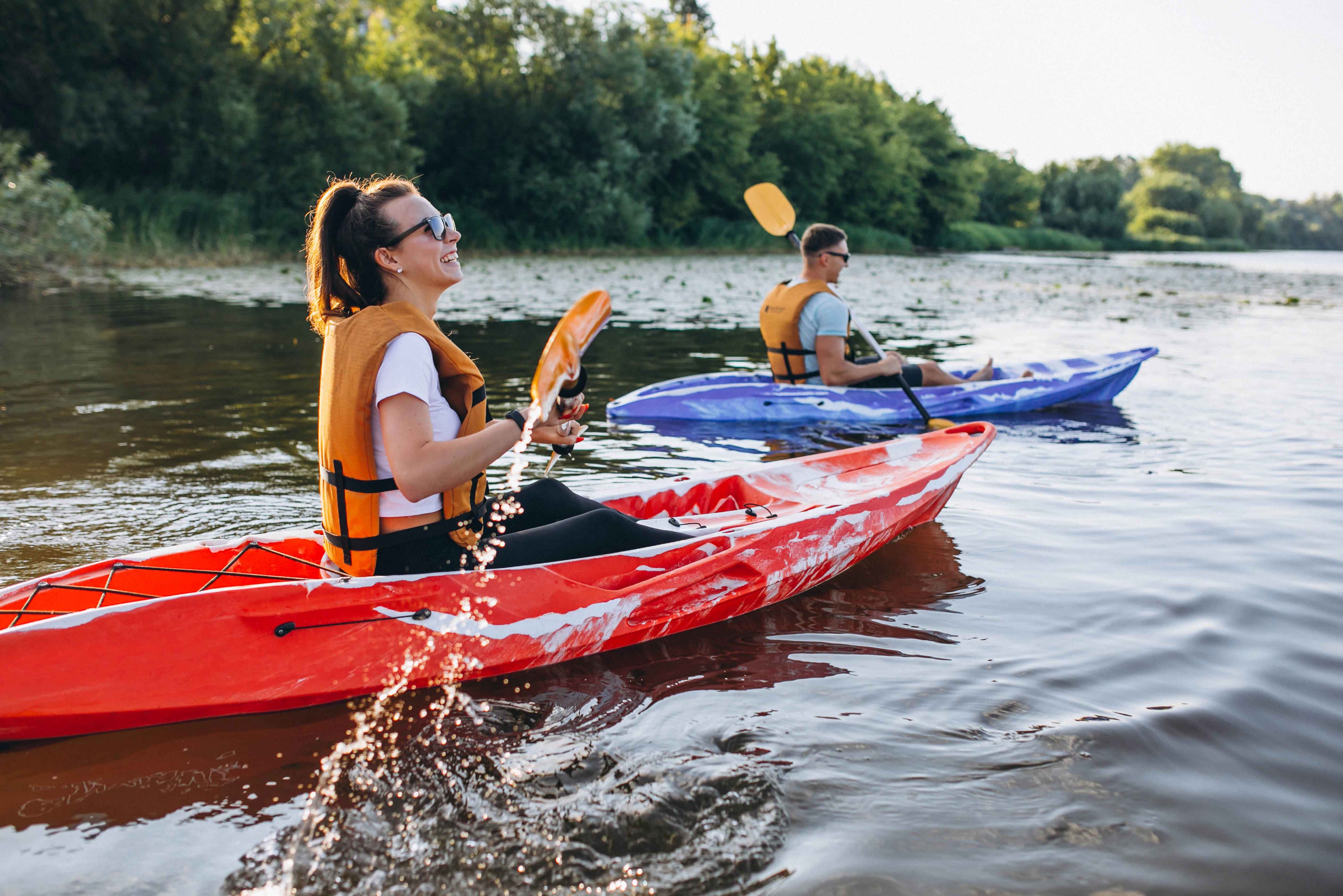 Couple kayaking on river