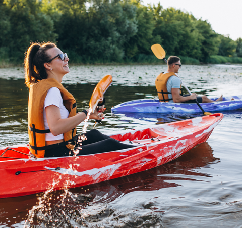 Couple kayaking on river